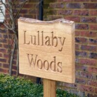 personalised-wooden-live-edge-rustic-house-sign-on-posts